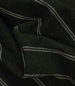 Draped black and white striped fabric with a heavyweight woven texture and soft structured folds.