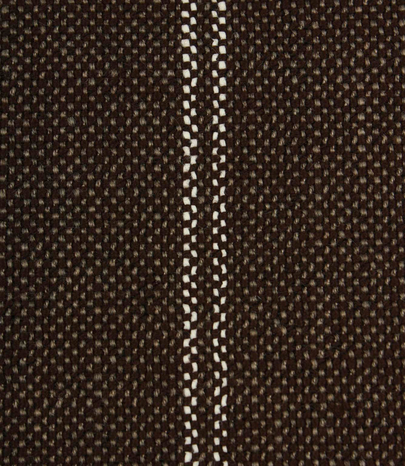 Close-up detail of coffee brown textured fabric featuring narrow white stitched stripe detailing.