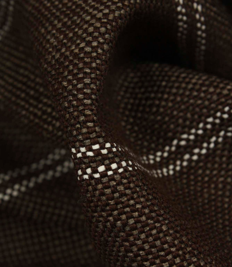 Macro detail of coffee brown upholstery fabric highlighting the textured weave and subtle white stitched stripes.