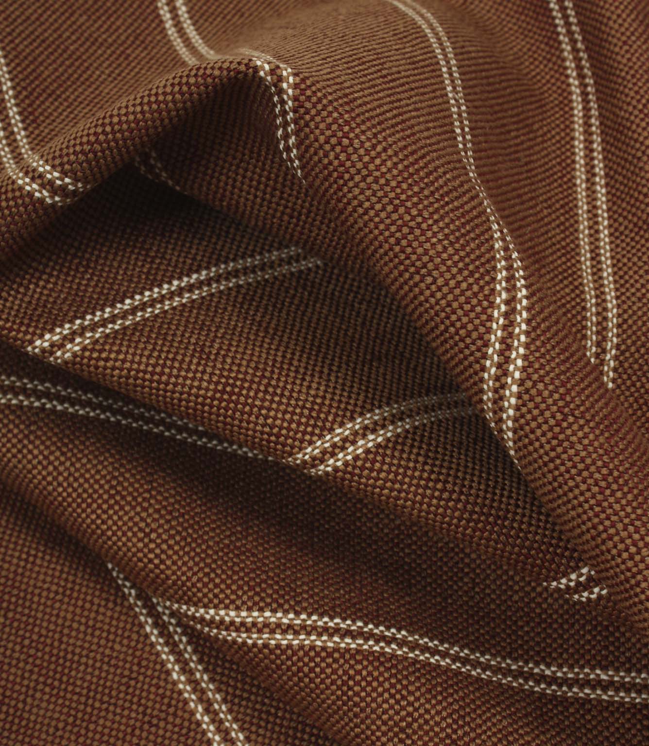 Draped copper brown woven fabric with delicate cream stripe pattern and soft flowing folds.