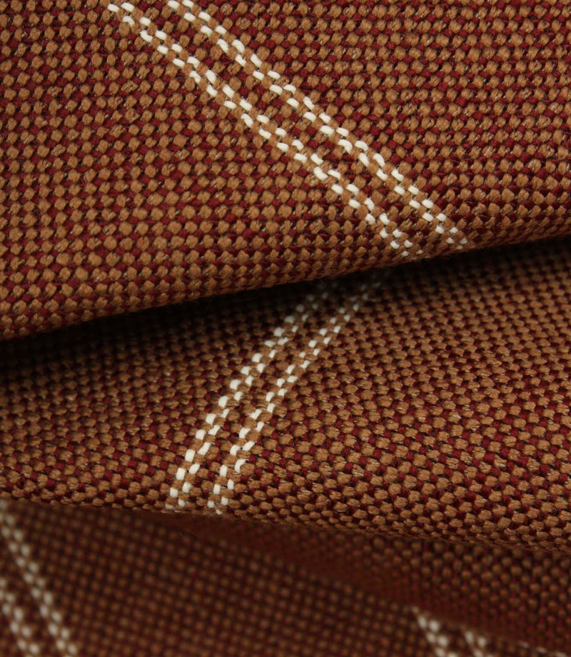 Macro detail of copper brown upholstery fabric showing the textured weave and subtle cream stitched stripes.