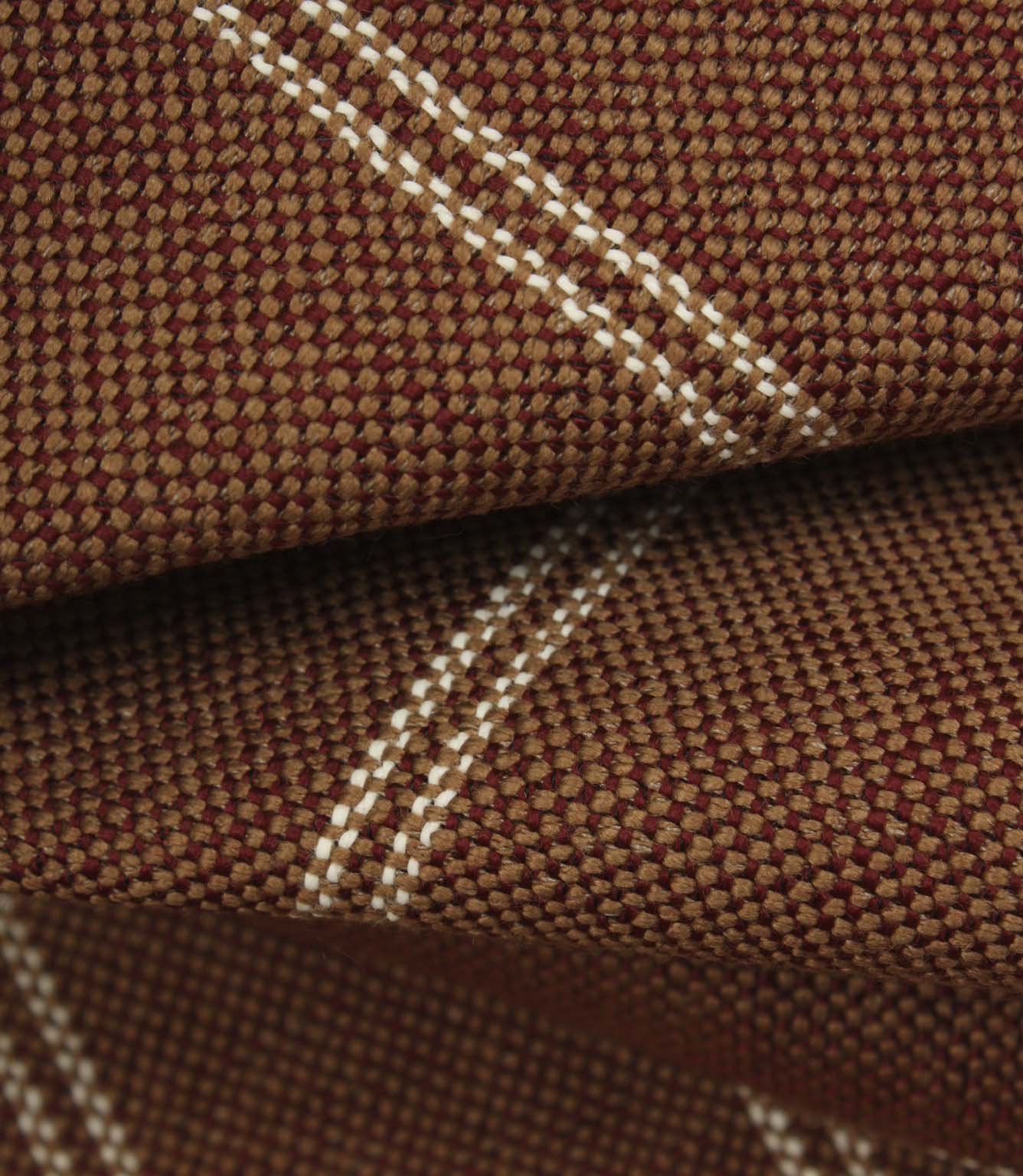 Macro detail of copper brown upholstery fabric showing the textured weave and subtle cream stitched stripes.
