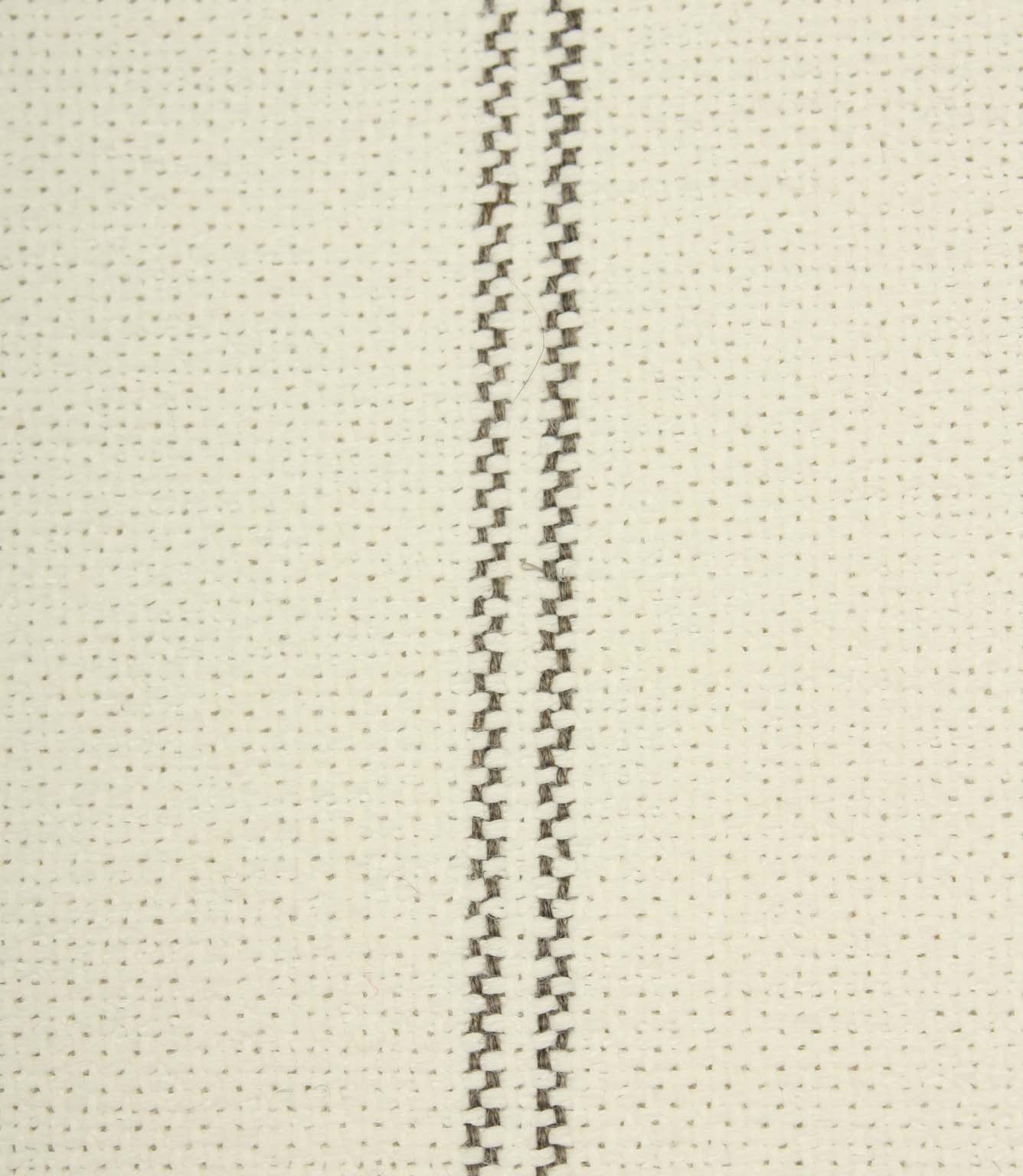 Close-up detail of ecru textured fabric featuring narrow grey stitched stripe detailing.