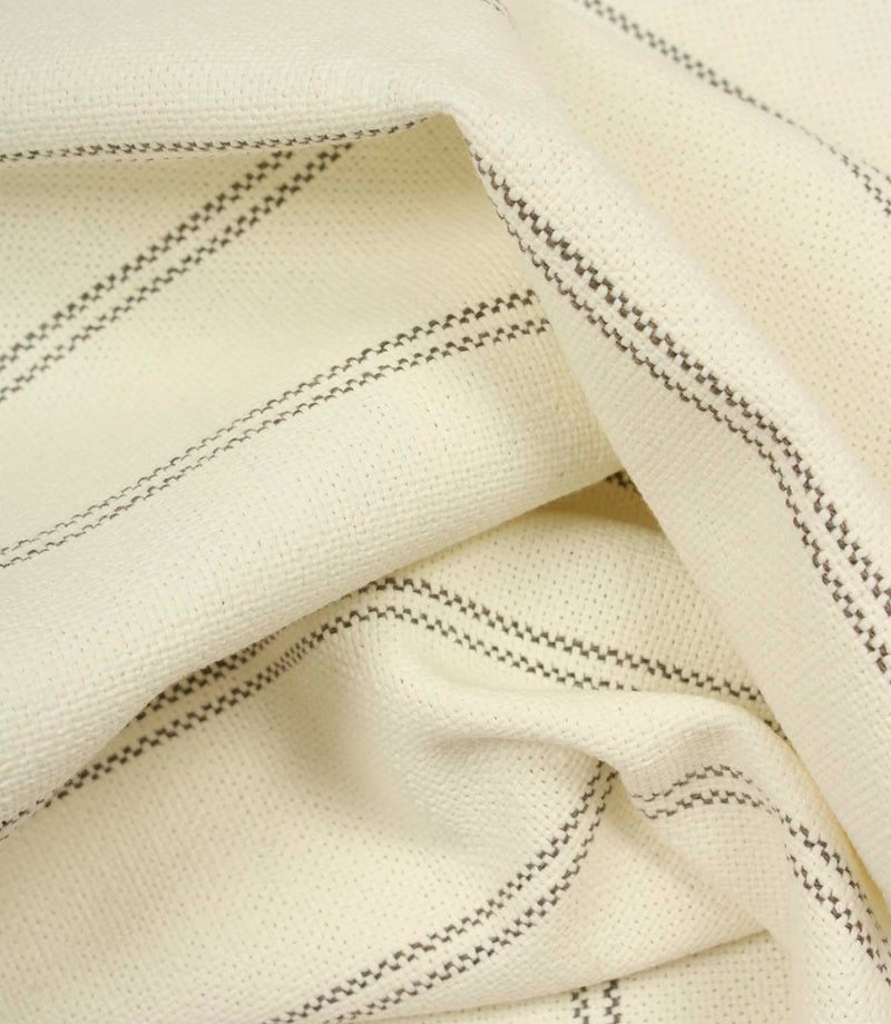 Draped ecru woven fabric with subtle grey stripe pattern and soft flowing folds.