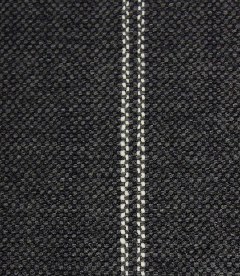 Close-up detail of ink blue textured fabric featuring narrow white stitched stripe detailing.