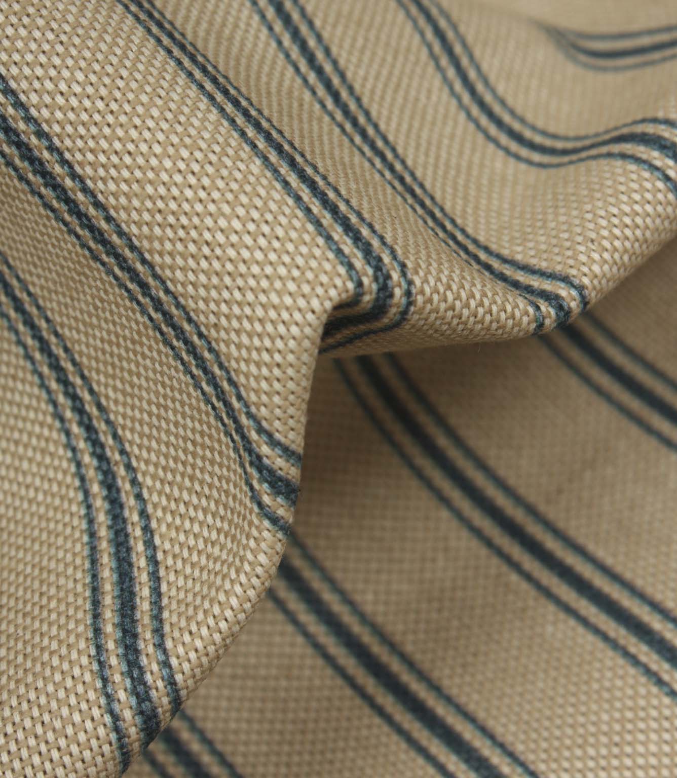 Close-up of textured woven stripe fabric showing detailed blue ticking stripes and natural-look weave structure.
