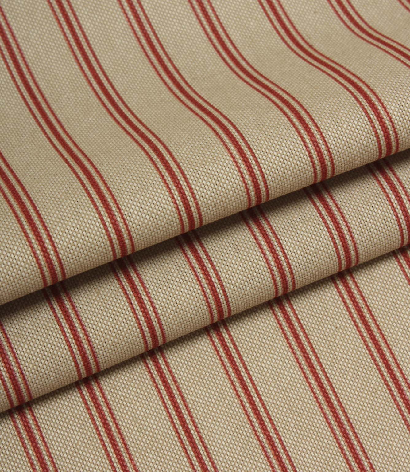 Folded beige and red striped fabric showing the scale of the ticking stripe pattern and woven construction.