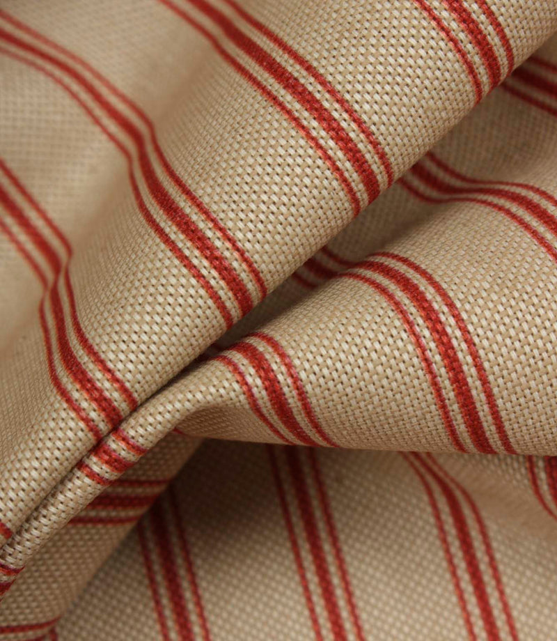 Detailed close-up of beige woven stripe fabric featuring textured weave and narrow red ticking stripes.