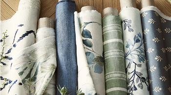 Collection of fabric swatches with various patterns on a wooden surface