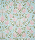 Rithani Robin's Egg fabric featuring a repeating botanical print of pink and cream pomegranates, delicate sage green foliage and slender stems on a soft duck egg blue background.