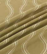 Close-up of Riverhead Kelp embroidered fabric draped into soft folds, showing raised ivory wavy stripes and delicate scalloped stitching on an olive green base.