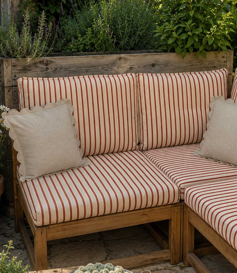 Striped outdoor sofa with scalloped cushions