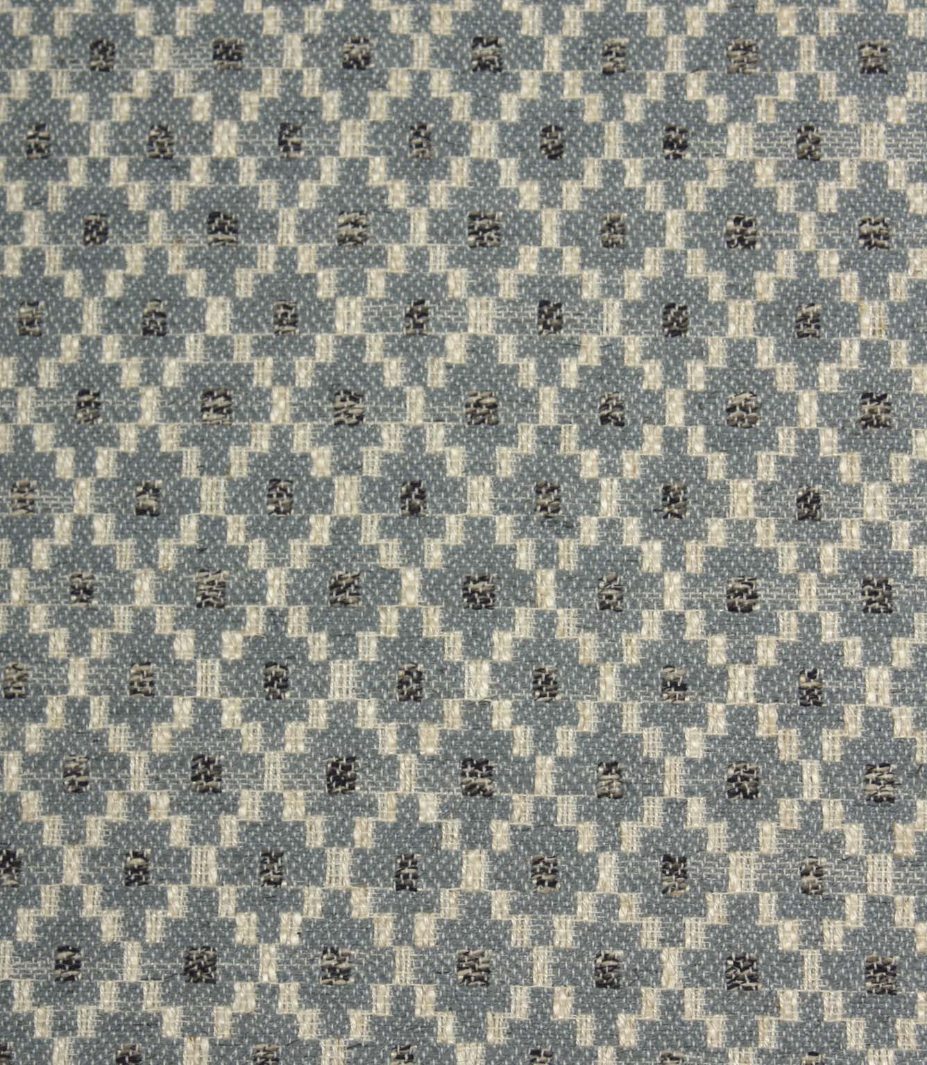 Close-up of Rossini Denim fabric highlighting the intricate geometric design and textured weave.