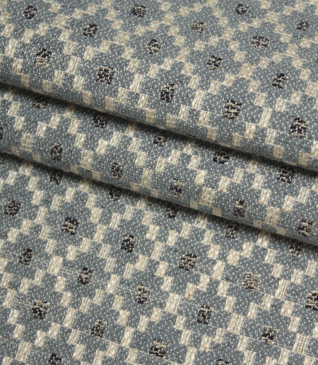 Folded Rossini Denim fabric showcasing the detailed woven pattern and rich textural finish.
