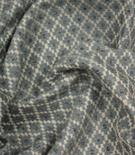 Draped Rossini Denim fabric displaying the geometric motif and soft, structured handle.