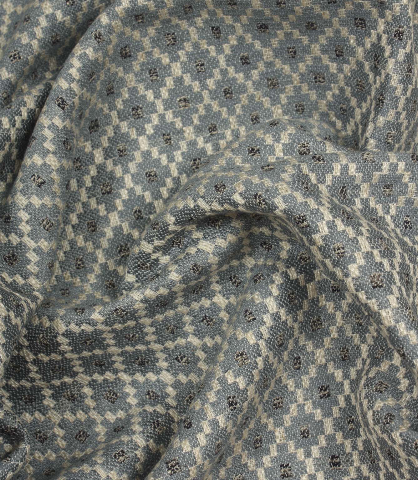 Draped Rossini Denim fabric displaying the geometric motif and soft, structured handle.