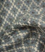 Detailed close-up of Rossini Denim fabric emphasising the woven texture and repeating geometric pattern.