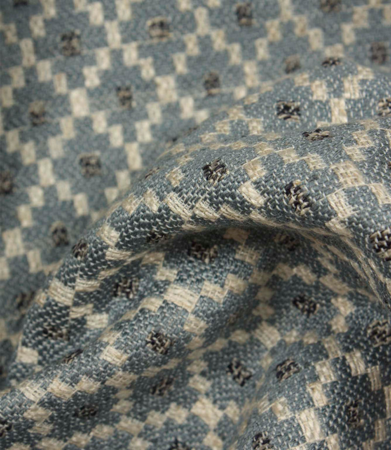 Detailed close-up of Rossini Denim fabric emphasising the woven texture and repeating geometric pattern.