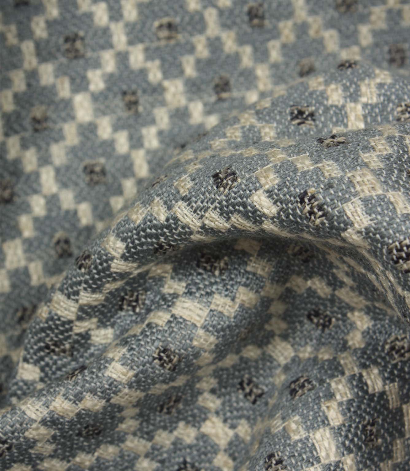 Detailed close-up of Rossini Denim fabric emphasising the woven texture and repeating geometric pattern.