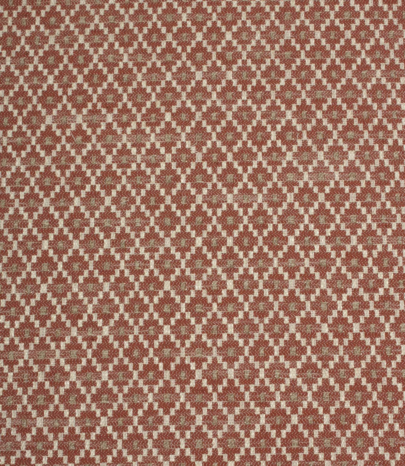 Rust red and cream woven fabric featuring a small-scale geometric pattern with soft taupe accents in a repeating lattice design.
