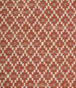 Close-up of textured upholstery fabric showcasing the intricate rust red geometric weave with cream detailing and subtle taupe highlights.
