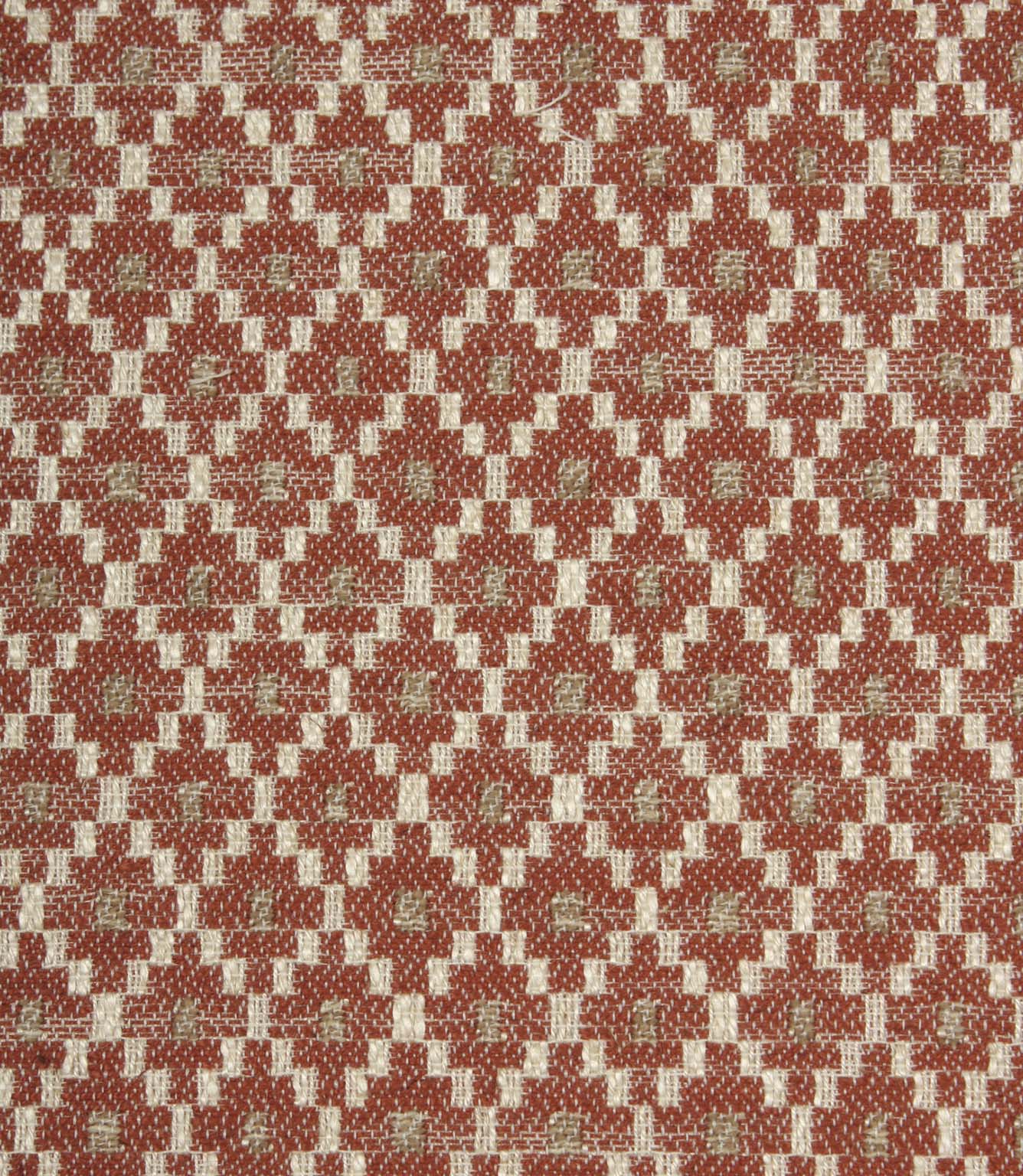 Close-up of textured upholstery fabric showcasing the intricate rust red geometric weave with cream detailing and subtle taupe highlights.