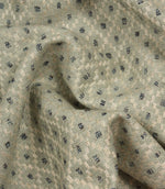 Draped Rossini Mineral fabric displaying the geometric motif and elegant fabric movement.