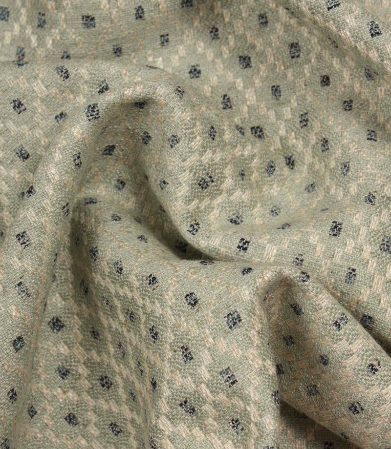 Draped Rossini Mineral fabric displaying the geometric motif and elegant fabric movement.