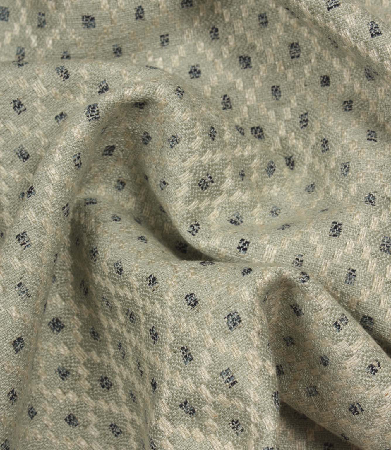 Draped Rossini Mineral fabric displaying the geometric motif and elegant fabric movement.