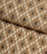 Folded Rossini Mocha fabric showcasing the intricate geometric design and upholstery-weight texture.
