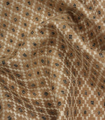 Draped Rossini Mocha fabric displaying the repeating geometric motif and soft, natural movement.
