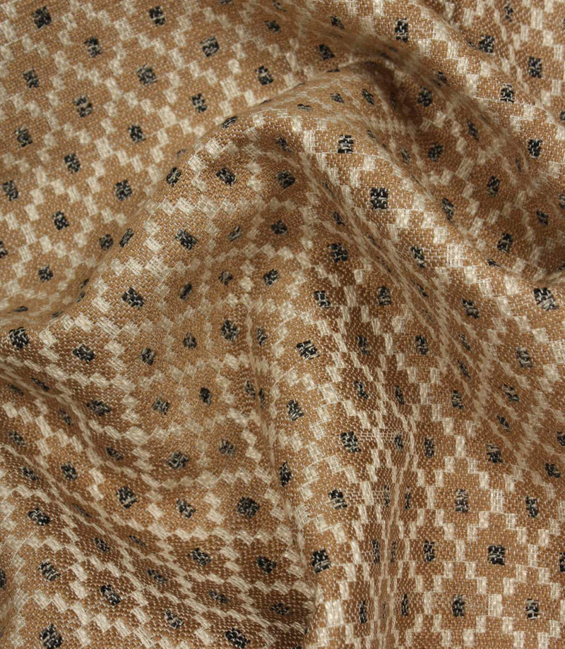 Draped Rossini Mocha fabric displaying the repeating geometric motif and soft, natural movement.