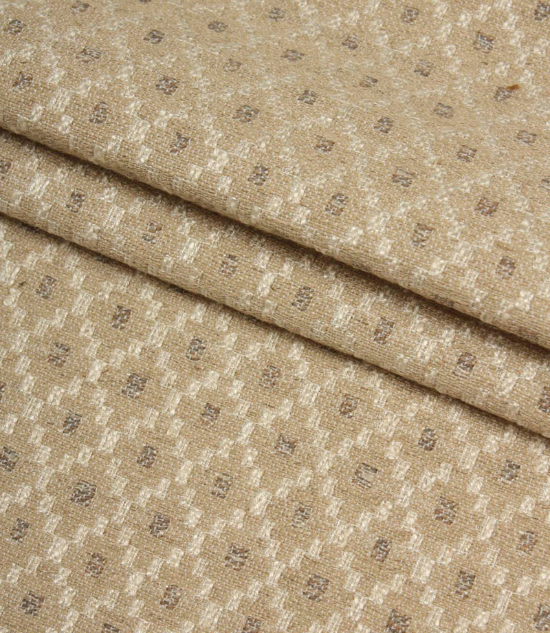 Folded Rossini Natural fabric highlighting the intricate geometric design and durable upholstery-weight texture.