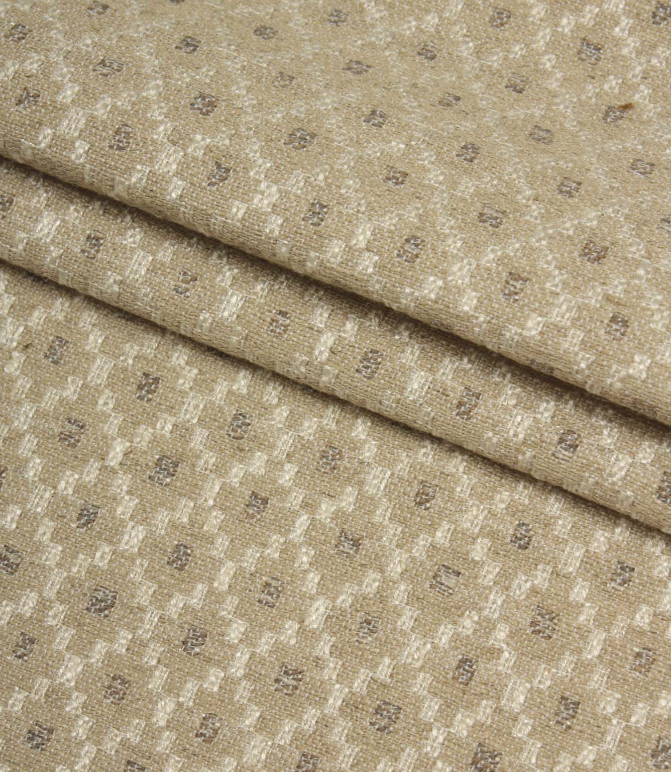 Folded Rossini Natural fabric highlighting the intricate geometric design and durable upholstery-weight texture.