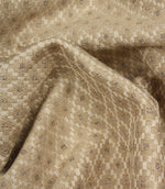 Draped Rossini Natural fabric displaying the repeating geometric motif and soft, elegant fabric movement.
