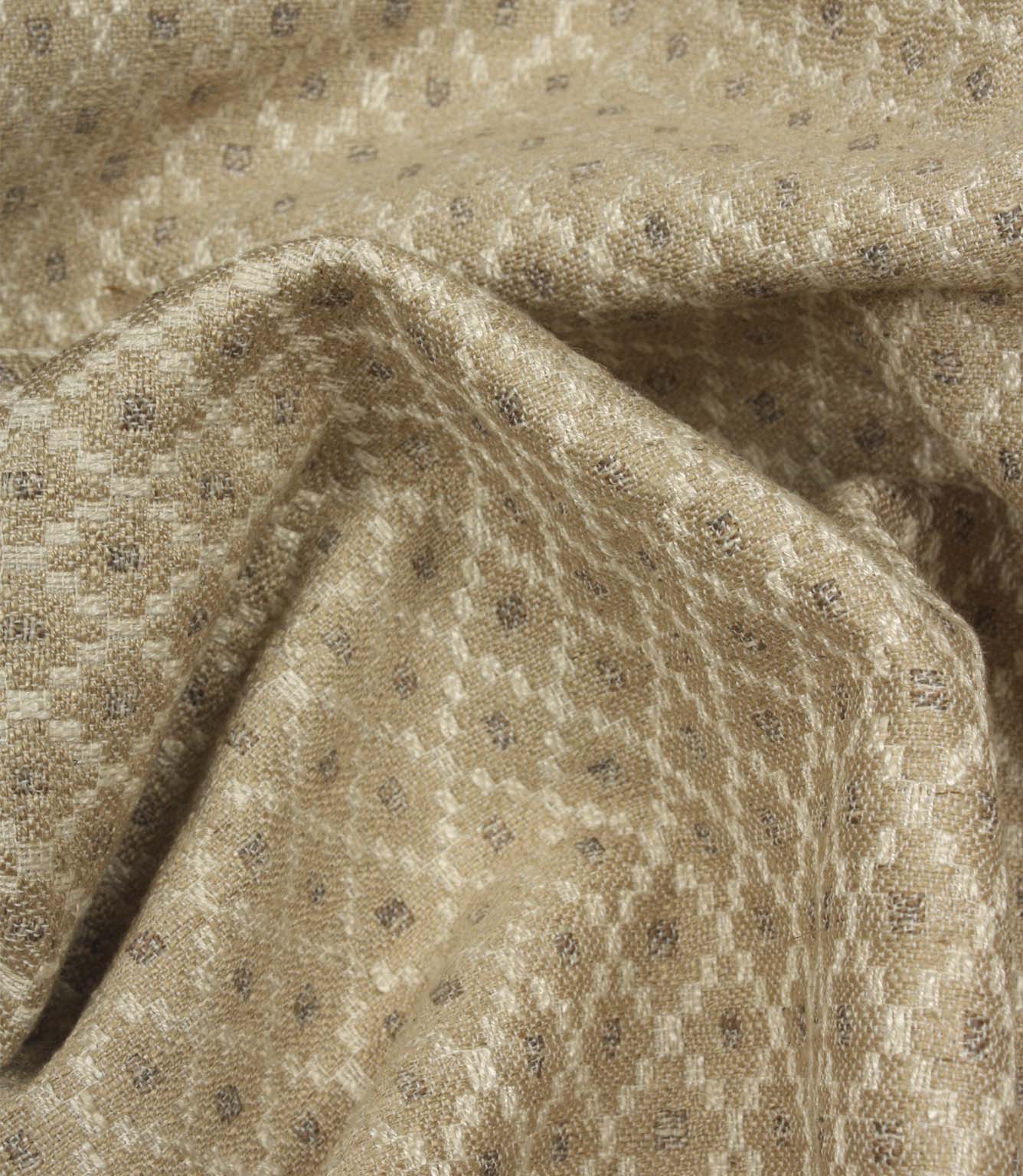 Draped Rossini Natural fabric displaying the repeating geometric motif and soft, elegant fabric movement.