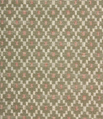 Close-up of textured upholstery fabric showcasing the intricate sage green geometric weave with cream detailing and subtle blush pink highlights.