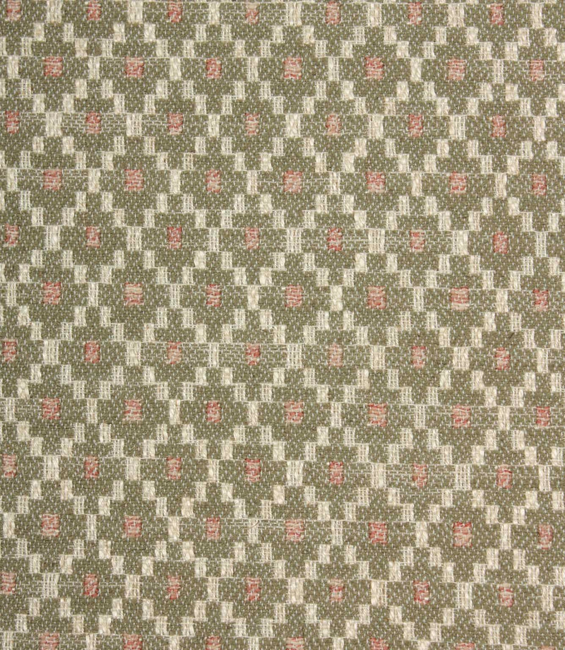 Close-up of textured upholstery fabric showcasing the intricate sage green geometric weave with cream detailing and subtle blush pink highlights.