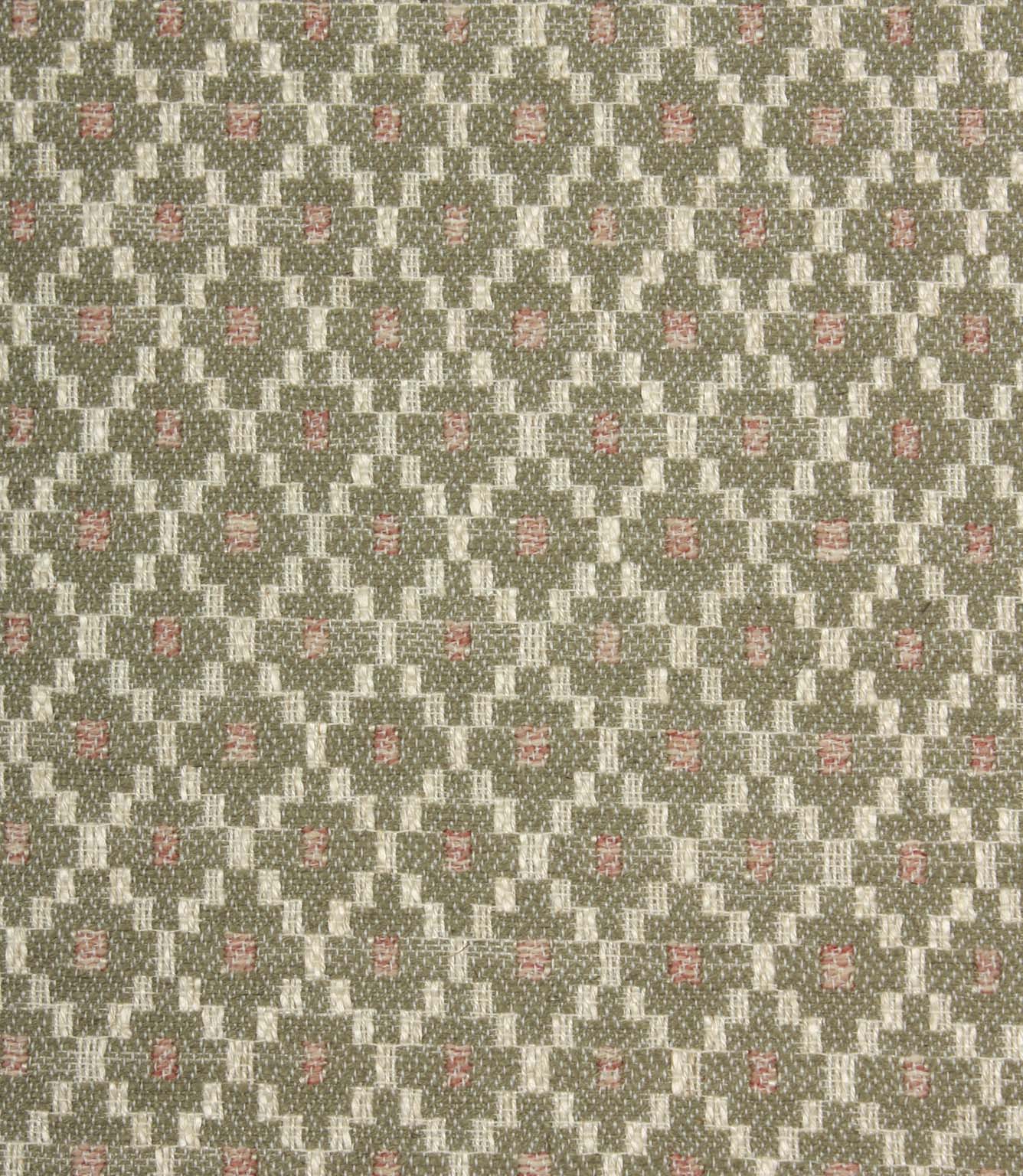 Close-up of textured upholstery fabric showcasing the intricate sage green geometric weave with cream detailing and subtle blush pink highlights.