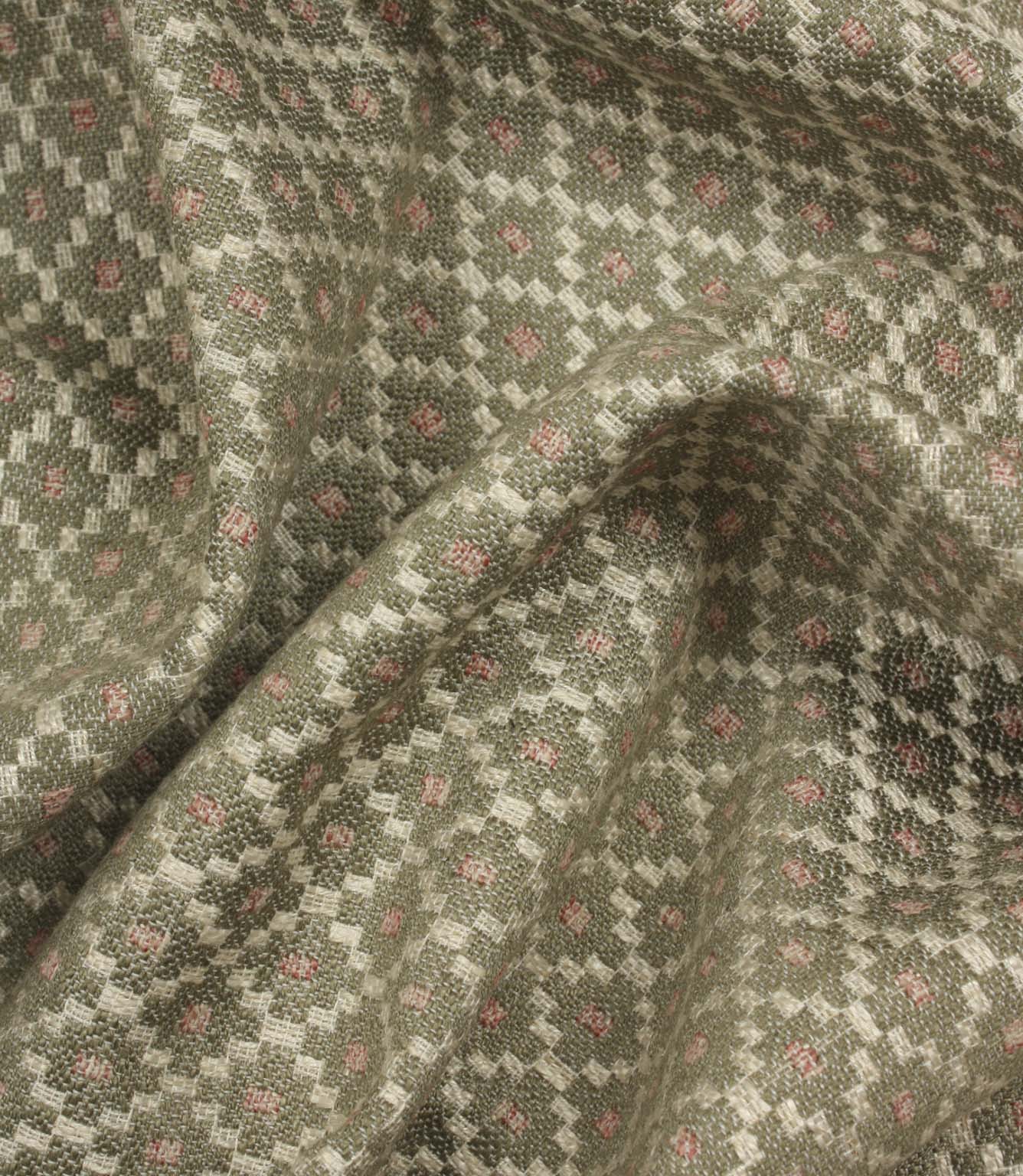 Draped geometric upholstery fabric with a soft woven handle and an intricate small-scale lattice-inspired pattern in muted earthy shades.