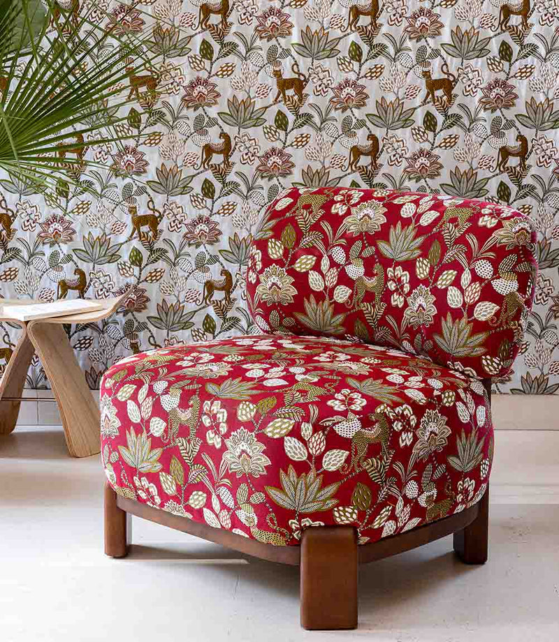 Floral-patterned armchair in a room with decorative wallpaper