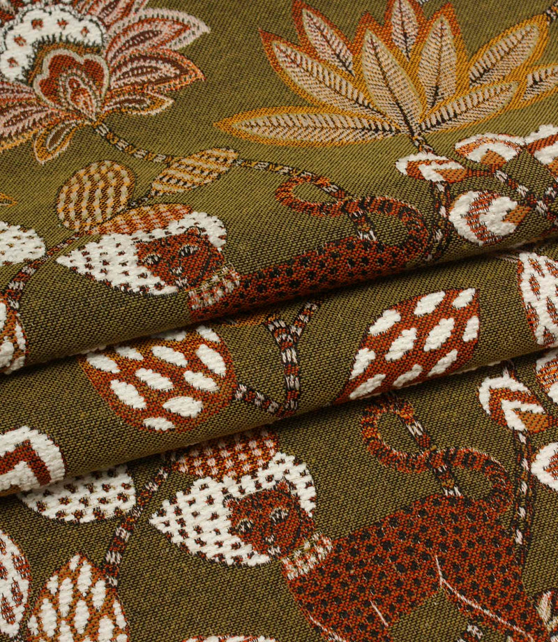 Folded olive green woven fabric featuring exotic leopards and large floral patterns in warm earthy tones.