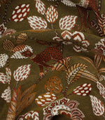 Draped olive green jacquard fabric with stylised jungle-inspired leopard and botanical design.