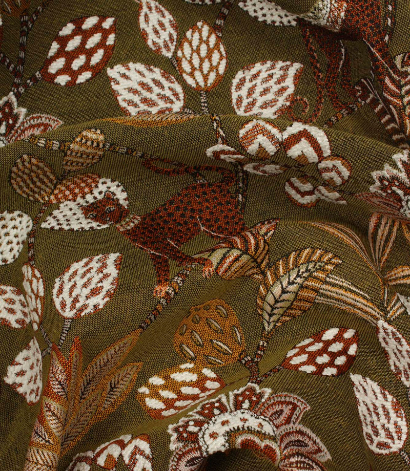 Draped olive green jacquard fabric with stylised jungle-inspired leopard and botanical design.