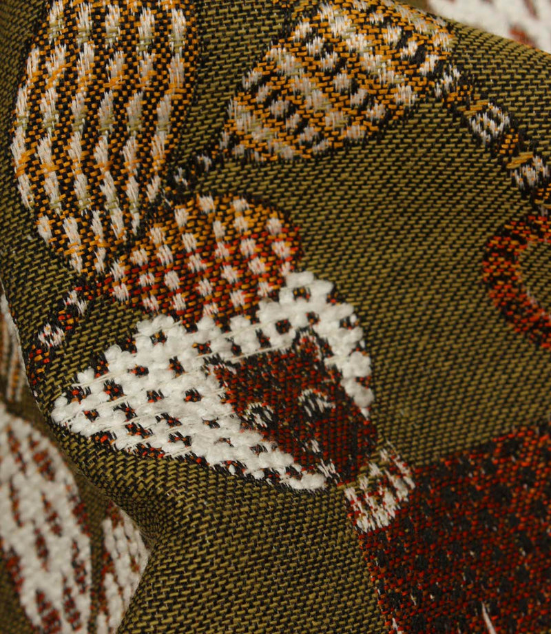 Detailed close-up of textured woven botanical fabric in olive green, rust and cream colourway.
