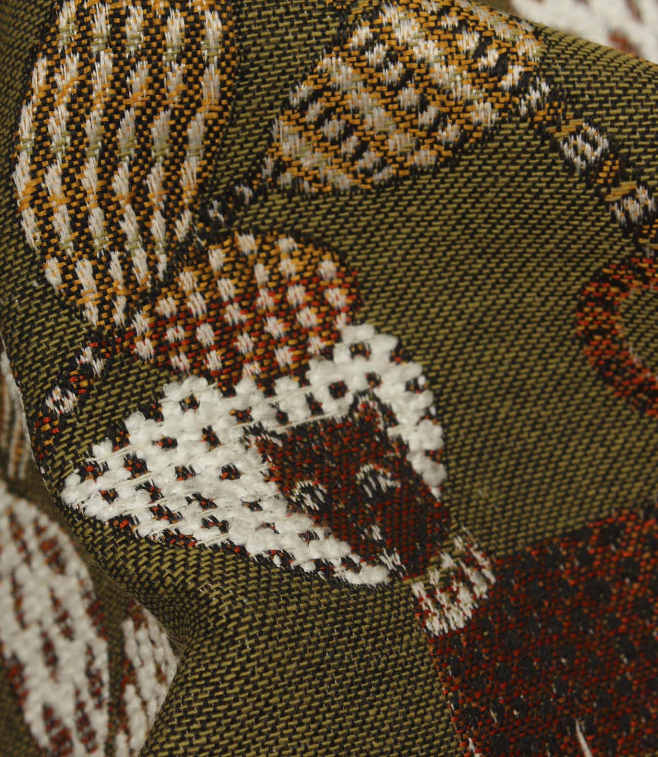 Detailed close-up of textured woven botanical fabric in olive green, rust and cream colourway.