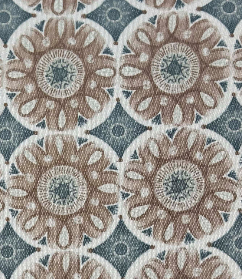 Close-up of Sand Rosette foliage outdoor fabric with stylised floral motifs in warm beige and dusty blue tones against a soft cream background.

