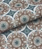 Folded Sand Rosette outdoor fabric featuring taupe floral medallion motifs with soft blue geometric detailing on an ivory background.