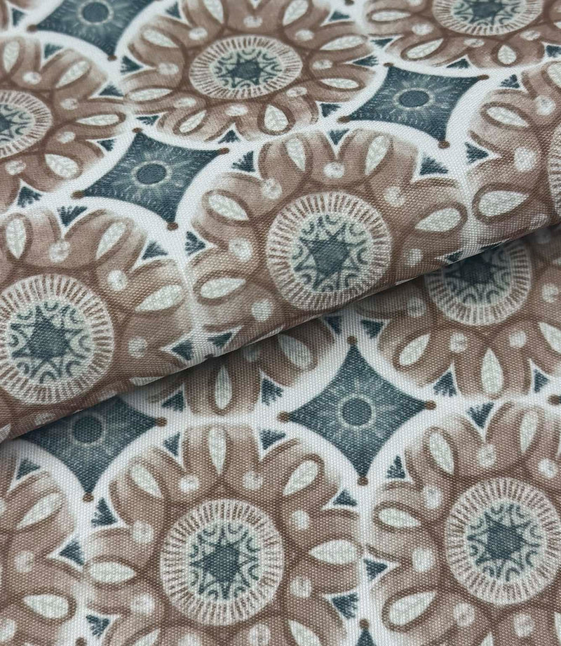 Folded Sand Rosette outdoor fabric featuring taupe floral medallion motifs with soft blue geometric detailing on an ivory background.