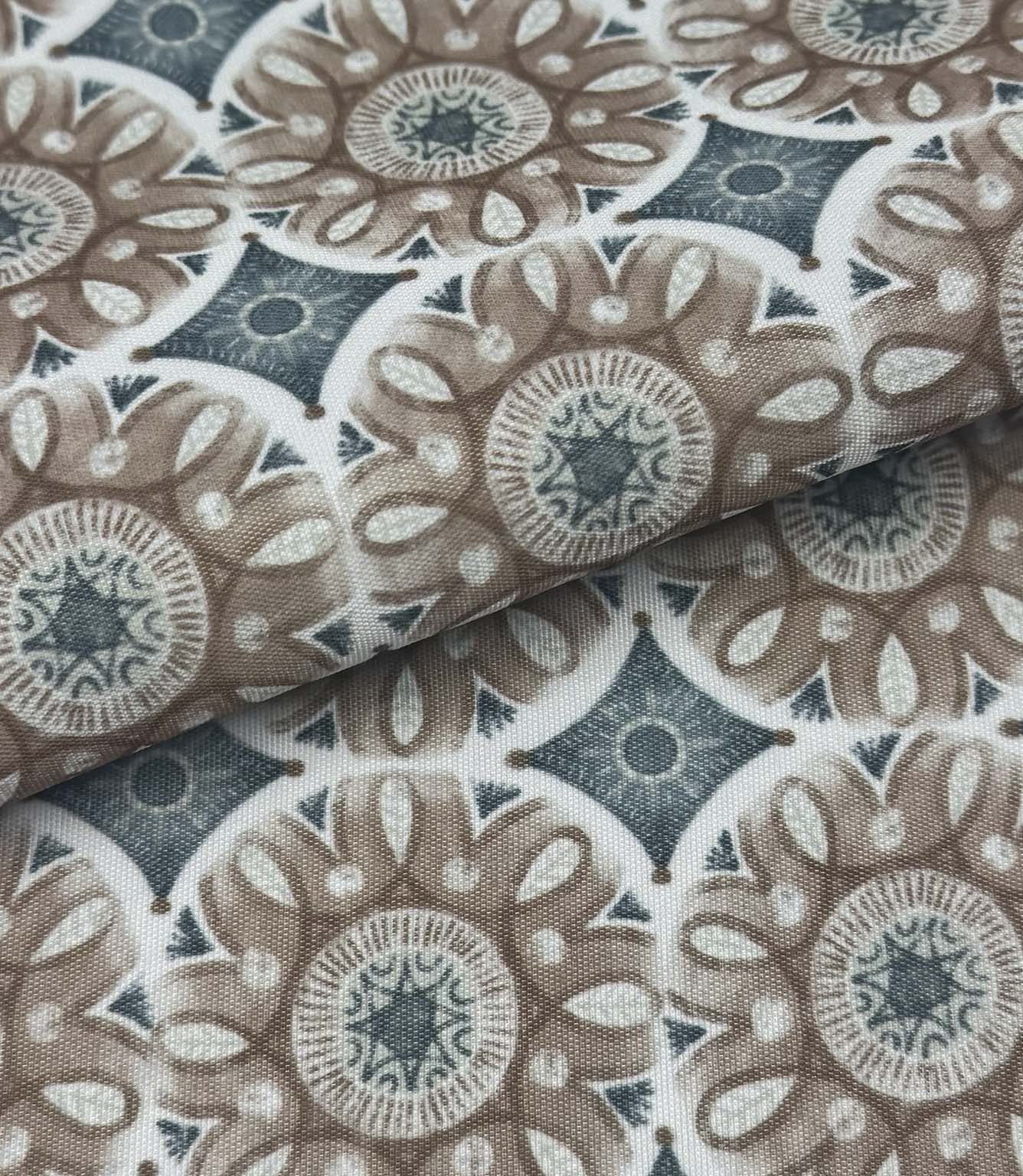 Folded Sand Rosette outdoor fabric featuring taupe floral medallion motifs with soft blue geometric detailing on an ivory background.